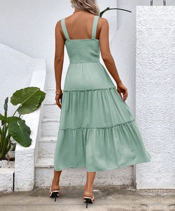Detail view of tiered summer dress with smocked back and wide straps in sage green