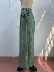 Detail of high waist geometric print wide leg trousers with matching fabric tie belt