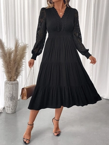 Detail of V-neck lace neckline and pleated waist on a black long-sleeved midi dress