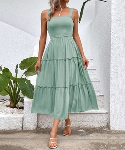 Sage green tiered midi dress with smocked bodice and square neck in soft woven fabric