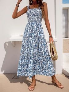 Detail of blue and white floral summer maxi dress with smocked bodice and tiered hem