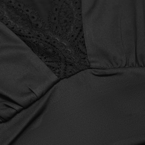 Close-up of the black V-neckline featuring elegant lace patchwork and fine knit texture