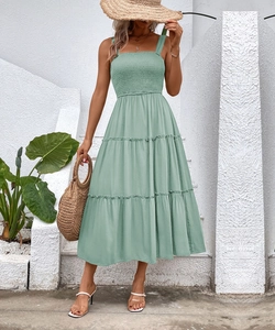 Detail of sage green smocked bodice and square neckline on a tiered summer dress