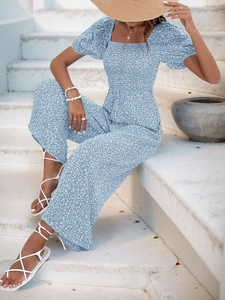 Detail of blue floral romper featuring square neck and puff sleeves for summer beach wear