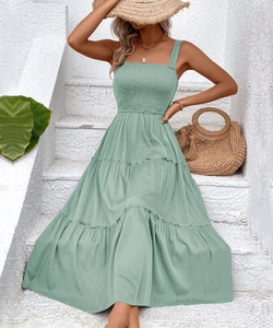 Detail of sage green tiered maxi dress featuring square neckline and smocked bodice detail