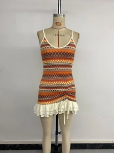 Detailed view of bohemian knit dress with geometric embroidery and drawstring ruffle hem