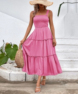 Detail of pink smocked bodice and tiered A-line skirt on a summer vacation dress