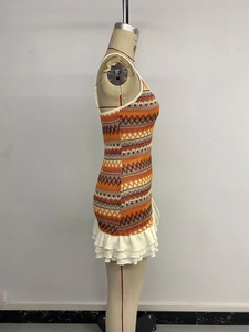 Detail of bohemian geometric knit mini dress with white tiered waffle ruffle hem