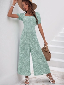 Close-up of green floral print jumpsuit featuring a square neck and puff sleeves