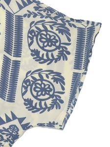 Detailed macro view of bohemian floral patterns and stitching on woven cotton fabric