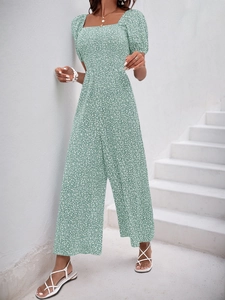 Detail of green floral wide-leg jumpsuit with vintage square neck and puffed sleeves