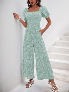 Close-up of green floral romper with square neckline and puff short sleeves detail
