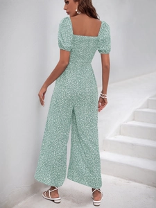 Detail view of green floral wide-leg jumpsuit with back elastic smocking and puff sleeves