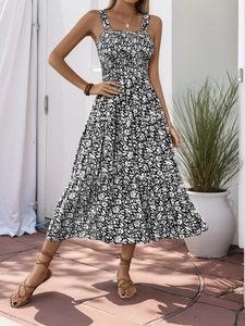 Detail of smocked square neck and floral pattern on tiered summer midi dress