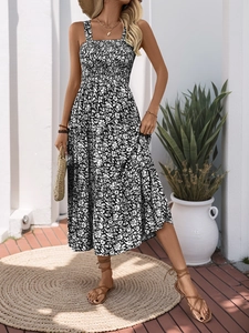 Detail view of the smocked bodice and tiered floral hem on a summer long dress