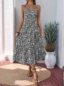 Detail of a black and white floral tiered maxi dress with smocked bodice and spaghetti straps