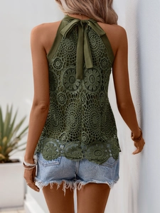 Detailed close-up of olive green lace halter top with floral patterns and bow tie back