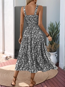 Back view of floral tiered midi dress featuring shirred elastic bodice and spaghetti straps