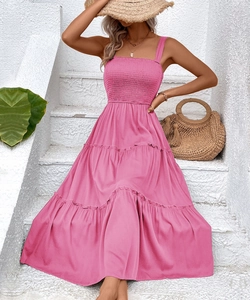 Detail of pink tiered summer dress featuring smocked bodice and bohemian vacation style