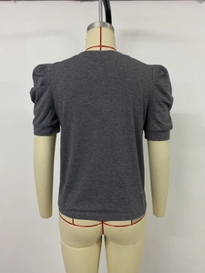 Detail view of the back of a charcoal grey puff sleeve knit top on a mannequin