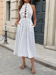 Detail of white polka dot dress featuring bow-tied cutouts and a halter neckline
