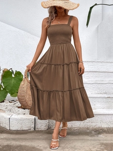 Detail of tiered skirt and smocked bodice on a brown summer sundress for beach vacations