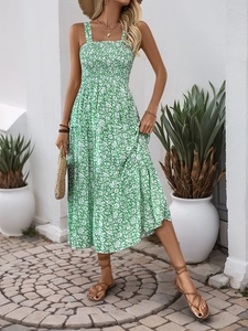 Detail of green floral tiered sun dress featuring stretchy smocked bodice and wide straps