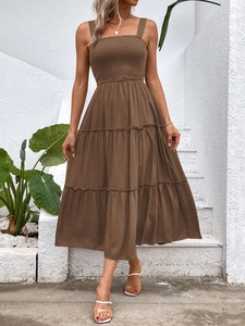 Detail of dark brown tiered sundress showing square neckline and smocked bodice texture