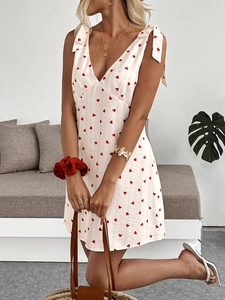 Detail of V-neck heart print mini dress with adjustable shoulder ties for summer style