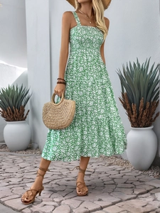 Detail of green floral summer dress showing smocked bodice and tiered ruffle skirt