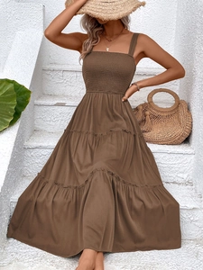 Detail of smocked bodice and tiered ruffle hem on a brown summer maxi dress