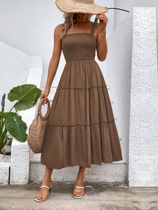 Detail of smocked waist and tiered ruffles on this solid brown sleeveless maxi dress