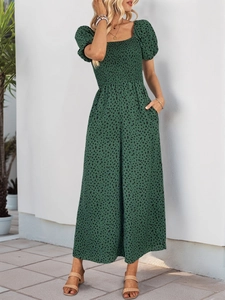 Detailed view of floral dark green romper with smocked bodice and side pockets