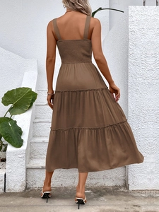 Detailed back view of tiered brown sun dress featuring smocked elastic bodice and wide straps