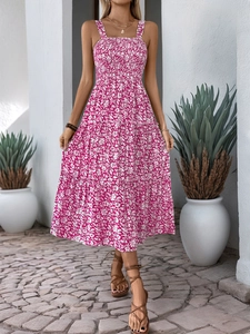 Detail of pink floral smocked bodice and tiered maxi dress skirt for summer