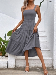 Detail of grey smocked bodice and tiered ruffled hem on a summer vacation dress