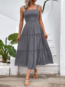 Detail of grey smocked bodice and square neck on tiered summer midi dress