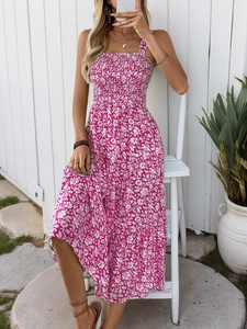 Detail of smocked bodice and floral pattern on a magenta bohemian summer maxi dress