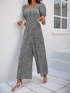Detail of floral print jumpsuit featuring a square neck and wide leg design for summer