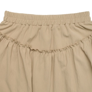 Detailed close-up of elastic waistband with ruffled trim on khaki tiered mini skirt