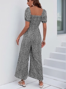 Floral jumpsuit featuring a square neckline, elastic smocked waist and wide leg cut