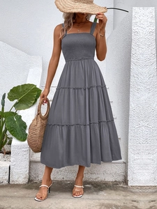 Detail view of grey tiered dress with smocked bodice and adjustable spaghetti straps