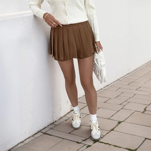 Detail of brown pleated corduroy mini skirt with thick texture for autumn style