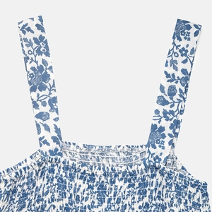 Detail of blue floral smocking dress featuring elastic pleated bodice and wide straps