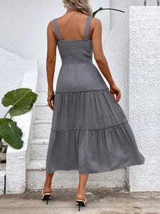 Close-up of gray tiered sundress featuring wide straps and smocked back detail