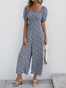 Close-up of navy blue floral jumpsuit with retro square neckline and puff sleeves