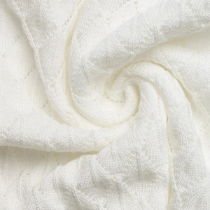 Gros plan détaillé du tissu en maille blanche avec motifs ajourés et textures fines