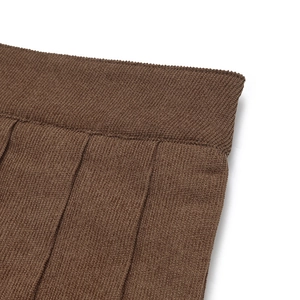 Detail shot of the brown corduroy fabric and pleated texture on this mini skirt