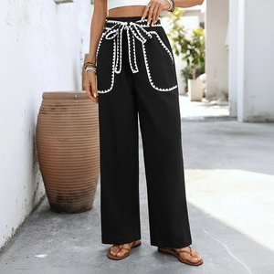 High-waisted black wide-leg trousers with white wave trim and self-tie bow waist