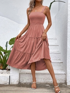 Detail of smocked bodice and layered tiered skirt on brick red summer sundress